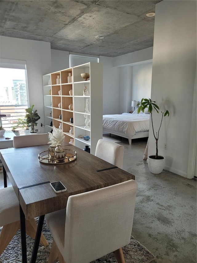 dining area featuring concrete floors