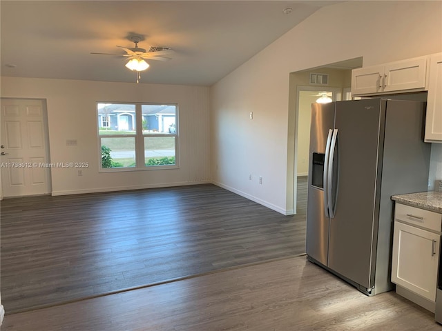 kitchen with stainless steel fridge, light hardwood / wood-style flooring, ceiling fan, white cabinetry, and vaulted ceiling