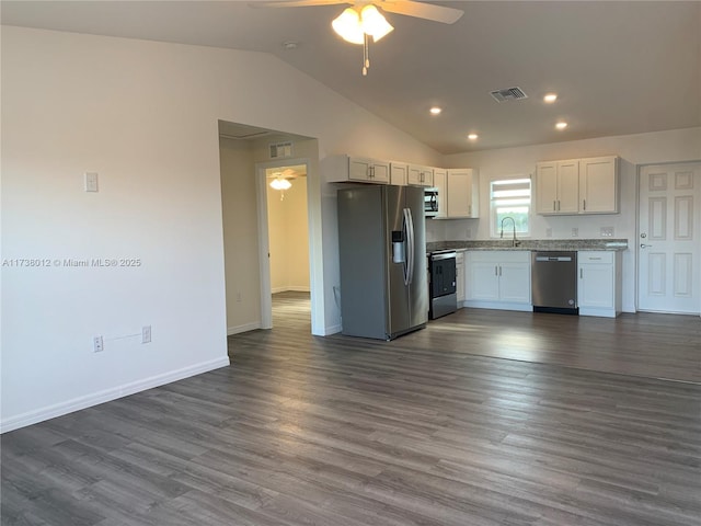 kitchen featuring lofted ceiling, sink, ceiling fan, white cabinetry, and stainless steel appliances