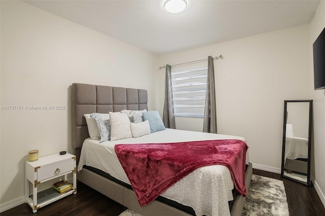 bedroom with dark wood-type flooring