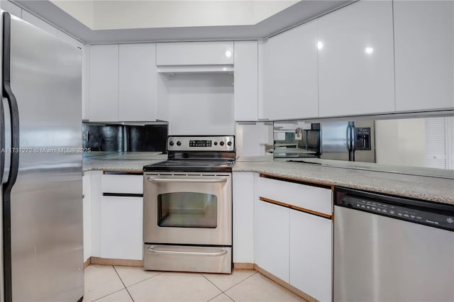 kitchen featuring white cabinetry, tasteful backsplash, stainless steel appliances, and light tile patterned flooring