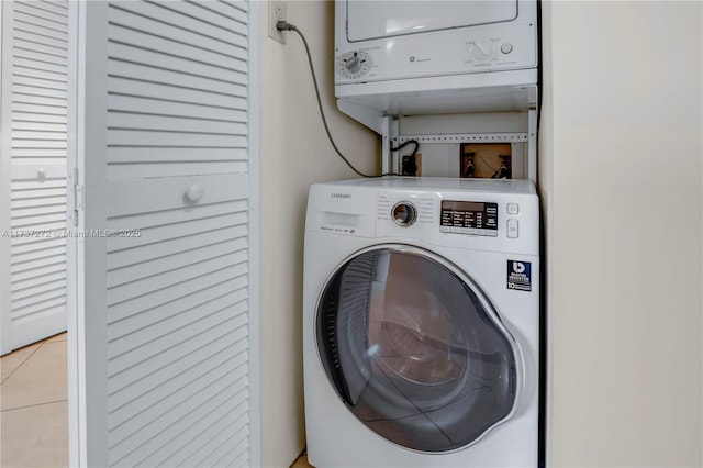 laundry area featuring stacked washer and clothes dryer