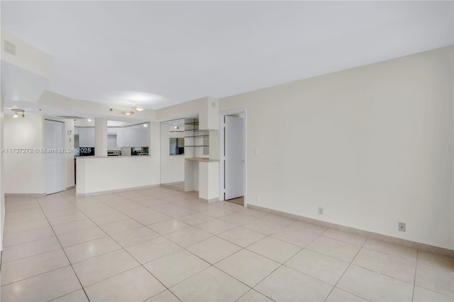 unfurnished living room featuring light tile patterned flooring