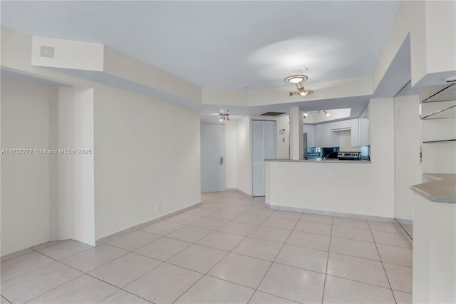 unfurnished living room featuring light tile patterned floors