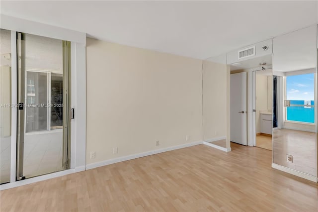 unfurnished room featuring light hardwood / wood-style flooring