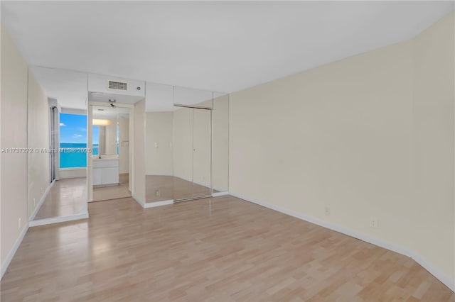 spare room with light wood-type flooring