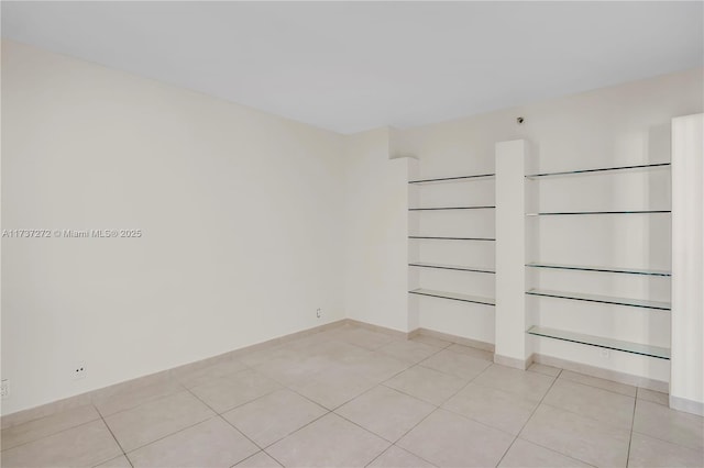 spare room with light tile patterned floors