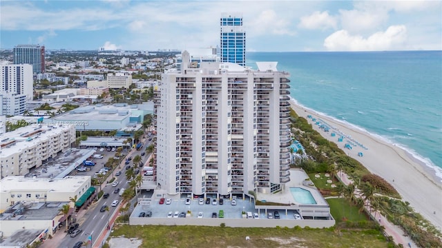 drone / aerial view featuring a water view and a beach view