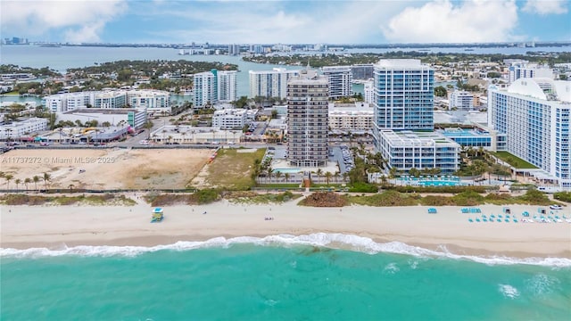 drone / aerial view with a water view and a beach view