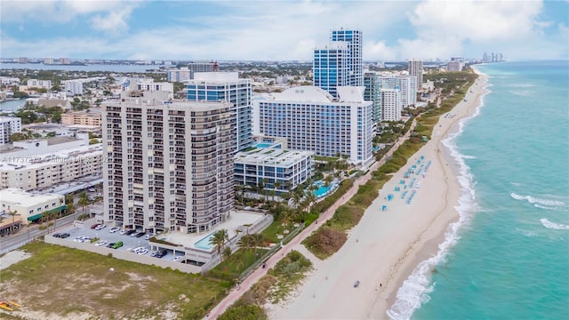 drone / aerial view featuring a water view and a beach view