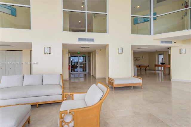 living room featuring a towering ceiling