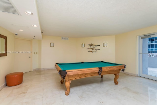 playroom featuring pool table and a textured ceiling