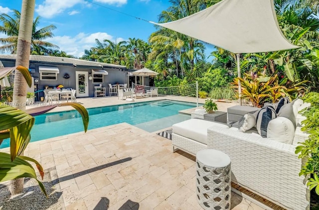 view of swimming pool with a fenced in pool, a patio, and an outdoor living space