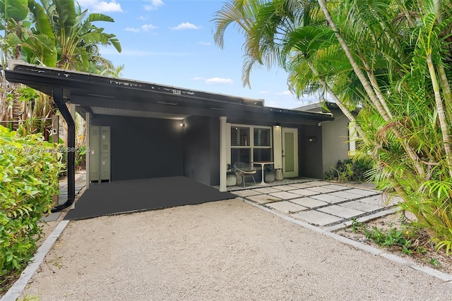 ranch-style house with a carport and stucco siding