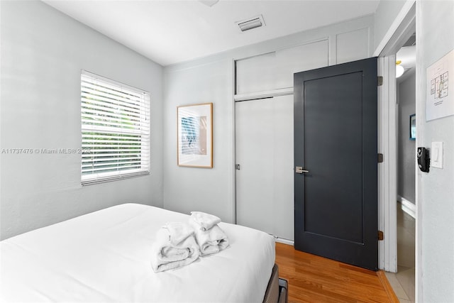 bedroom with a closet and wood finished floors