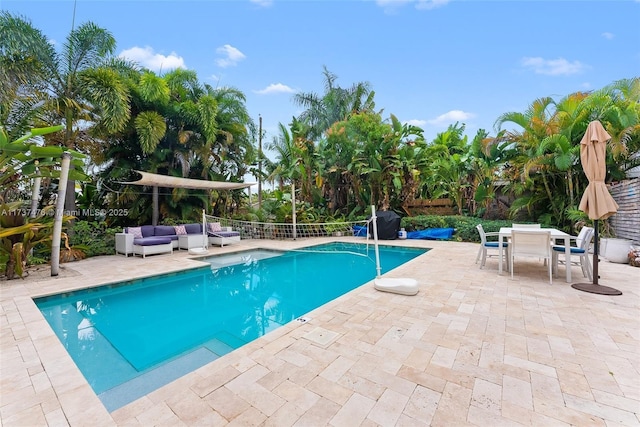 view of pool featuring outdoor lounge area, outdoor dining area, a fenced in pool, and a patio