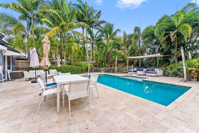 view of swimming pool with a fenced in pool, outdoor dining space, a patio area, fence, and an outdoor living space