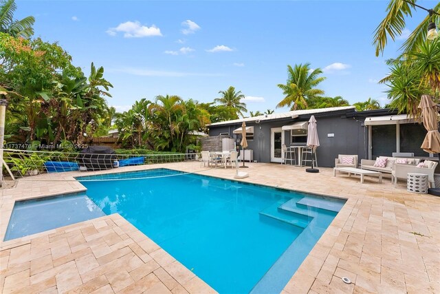 1528 NE 17th Ter, Fort Lauderdale, FL 33304 - view of pool with an outdoor living space, a fenced in pool, fence, a patio, and outdoor dry bar