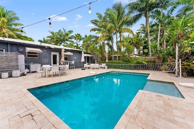 view of pool with a fenced in pool, a patio area, and fence