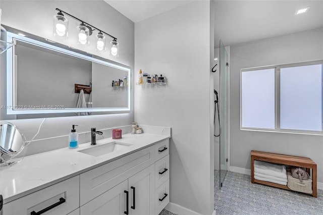 bathroom with vanity and a shower