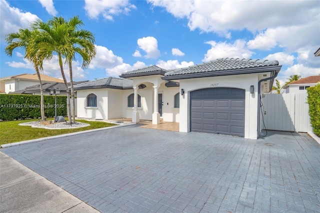 mediterranean / spanish home featuring a garage