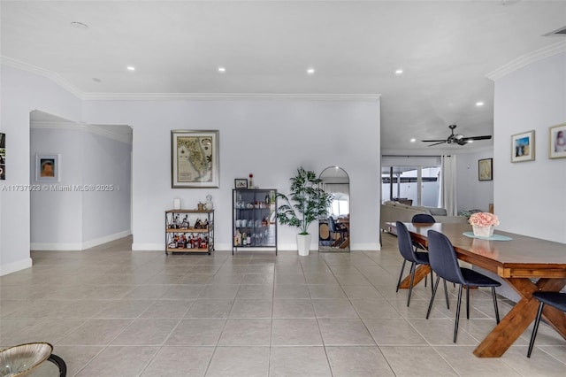 dining area with ornamental molding, ceiling fan, and light tile patterned flooring