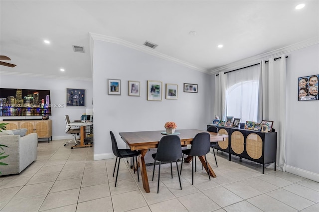 tiled dining room with ceiling fan and ornamental molding