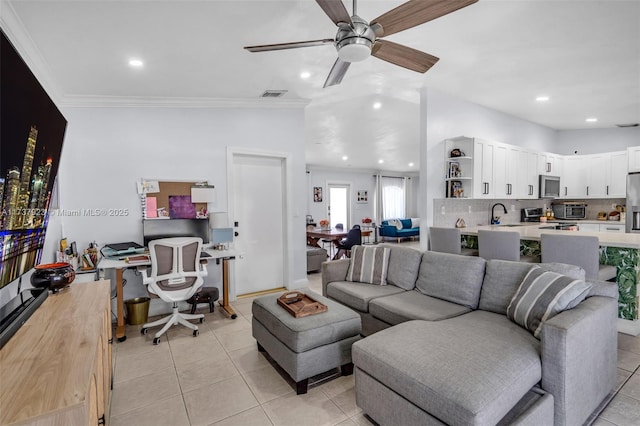 tiled living room with ornamental molding, lofted ceiling, sink, and ceiling fan