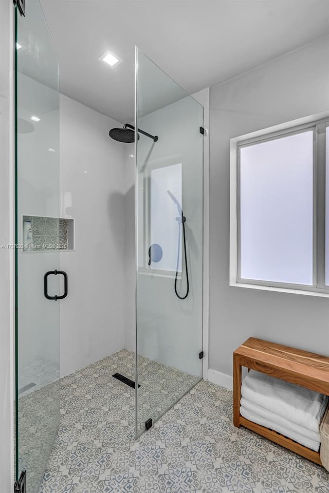 bathroom featuring a shower with shower door