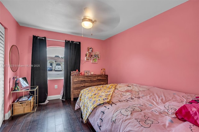 bedroom with dark wood-type flooring and ceiling fan