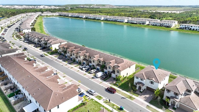 drone / aerial view featuring a water view and a residential view