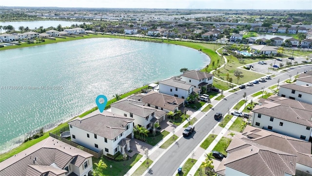 drone / aerial view featuring a water view and a residential view