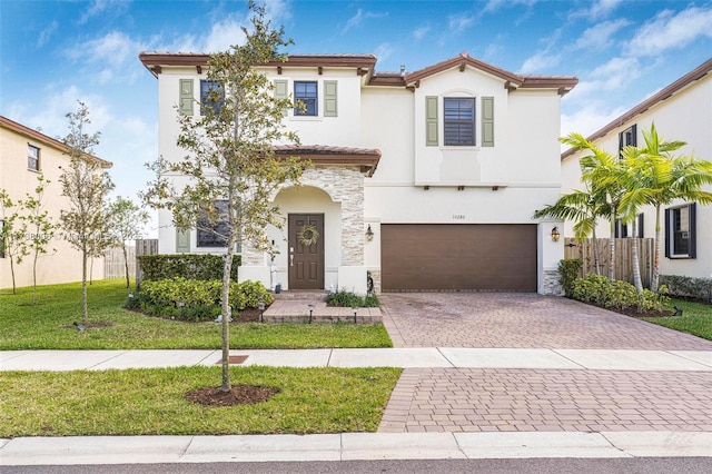 mediterranean / spanish-style house with a garage, stone siding, a tile roof, decorative driveway, and stucco siding