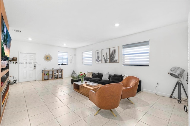 living area featuring light tile patterned floors, baseboards, visible vents, and recessed lighting