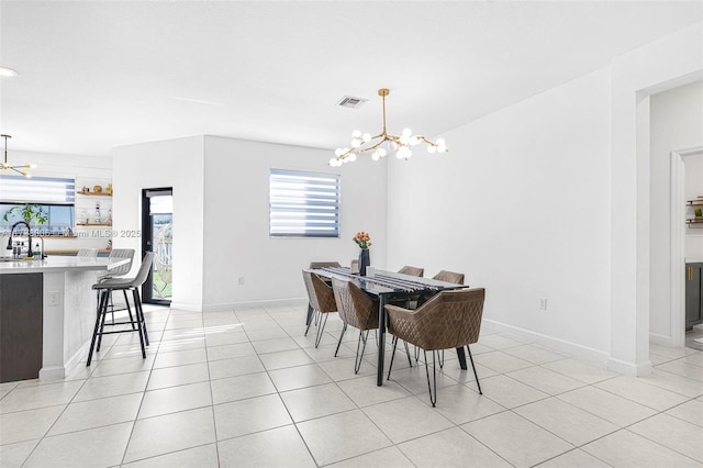 dining room with light tile patterned floors, baseboards, visible vents, and an inviting chandelier