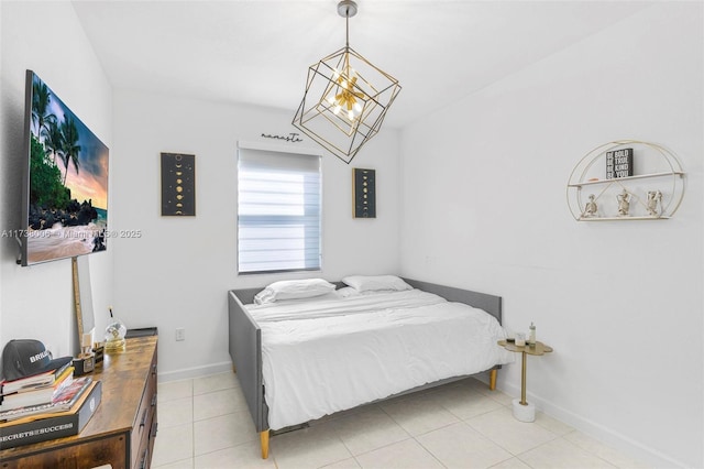 bedroom with an inviting chandelier, baseboards, and light tile patterned flooring