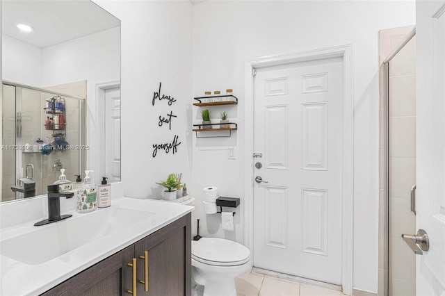 bathroom with a stall shower, tile patterned flooring, vanity, and toilet