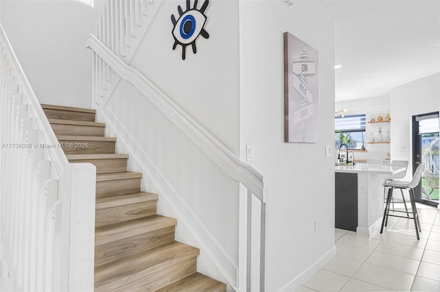 staircase with tile patterned floors