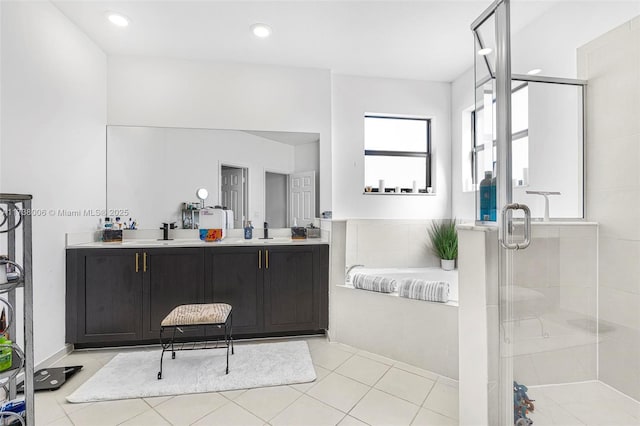 bathroom featuring tile patterned floors, a sink, a shower stall, and double vanity