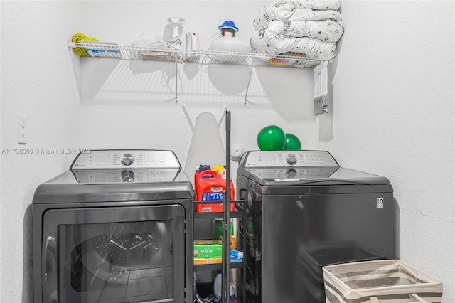 washroom featuring laundry area and washer and dryer