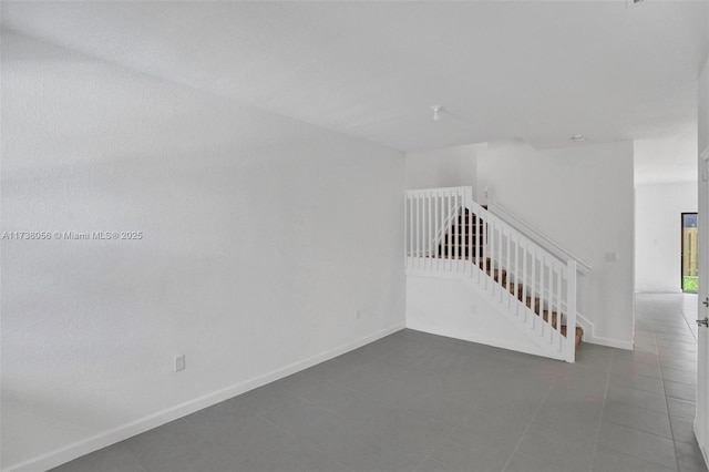 empty room with dark tile patterned floors