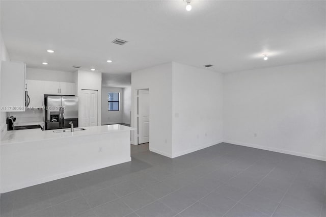 unfurnished living room with sink