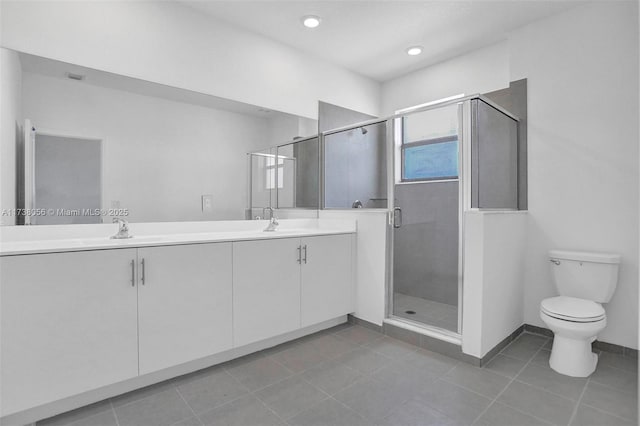 bathroom with walk in shower, vanity, toilet, and tile patterned flooring