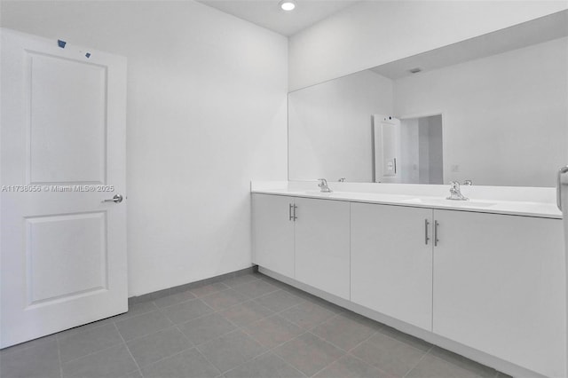 bathroom featuring tile patterned flooring and vanity