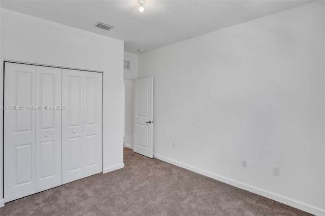 unfurnished bedroom featuring a closet and light carpet