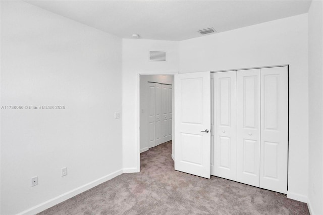 unfurnished bedroom featuring light carpet