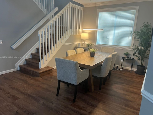 dining space featuring dark hardwood / wood-style flooring and crown molding