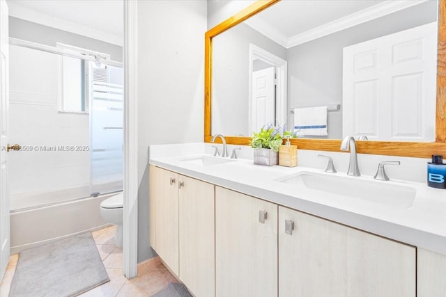 bathroom with crown molding, toilet, a sink, and double vanity