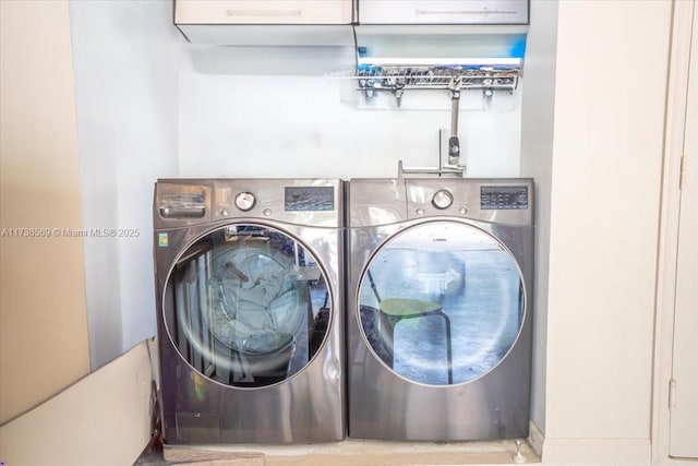 clothes washing area with independent washer and dryer and laundry area