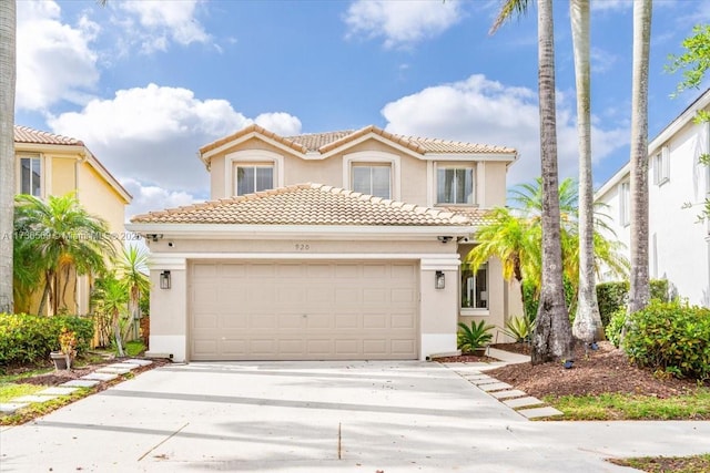 mediterranean / spanish-style home featuring stucco siding, driveway, and a tile roof